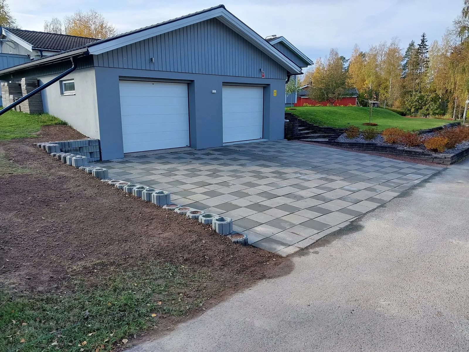 Färdig marksten-infart med kantsten framför garaget